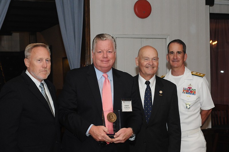 John Artzen, Chairman of the U.S. Merchant Marine Academy (USMMA) Alumni Association (far left), Rear Admiral Mark H. Buzby, USN, Ret., Maritime Administrator (third from left), and Rear Admiral James Helis, USMS, USMMA Superintendent (far right), present the Outstanding Professional Achievement Award to Robert Clyne, ABS Senior Vice President, General Counsel and Corporate Secretary.