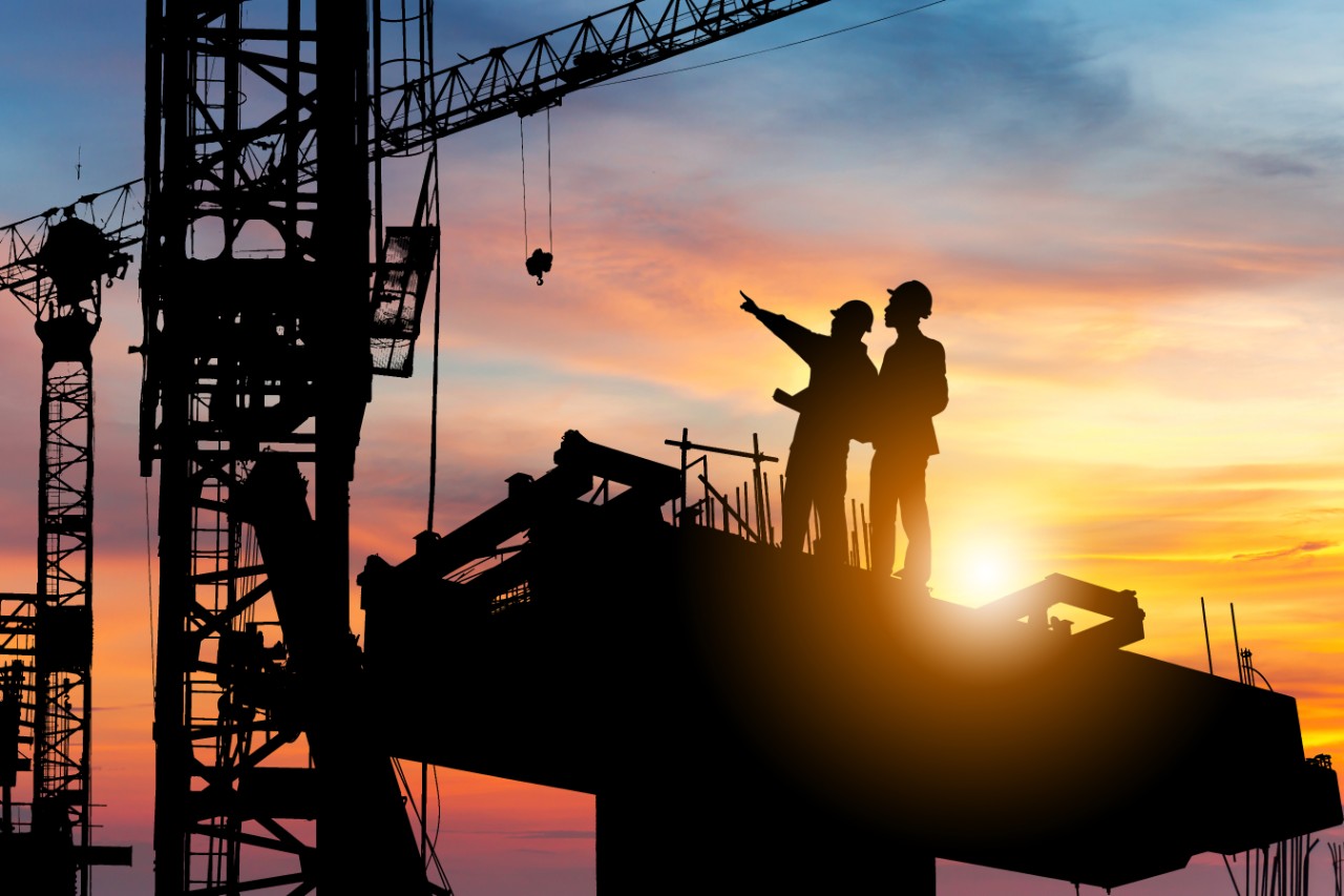 Silhouette of Engineer and worker checking project at building site background, construction site at sunset in evening time.; Shutterstock ID 1588752748; purchase_order: Graphics; job: ; client: Chris Reeves; other: