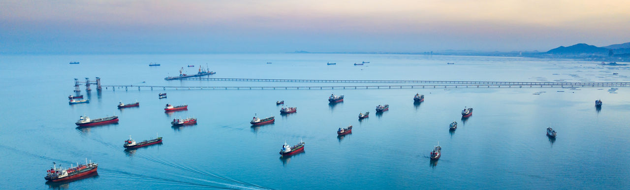 Aerial view from drone, Oil tanker ships off the coast in beautiful light sundown, professional business logistics and transportation of energy fuels.; Shutterstock ID 1252192840; purchase_order:2024 Outlook; job:; client:Shannon Crisafulli; other: