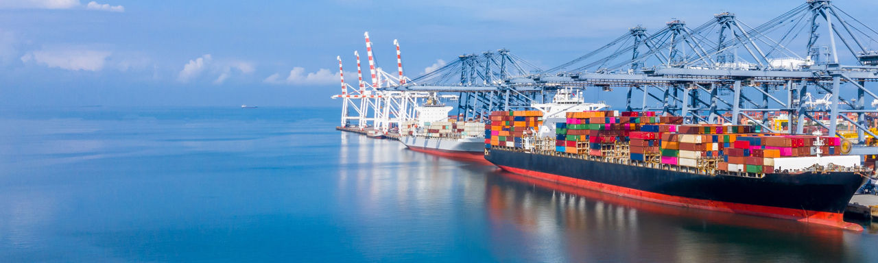 Container ship at industrial port in import export global business logistic and transportation, Container ship loading and unloading freight shipment, Aerial view container cargo boat freight ship.