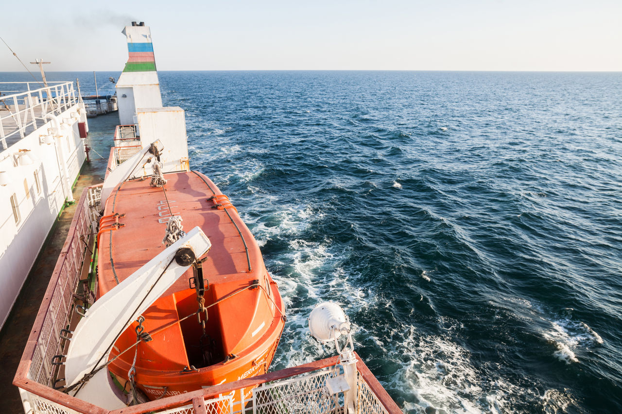 orange lifeboat on a passenger ship