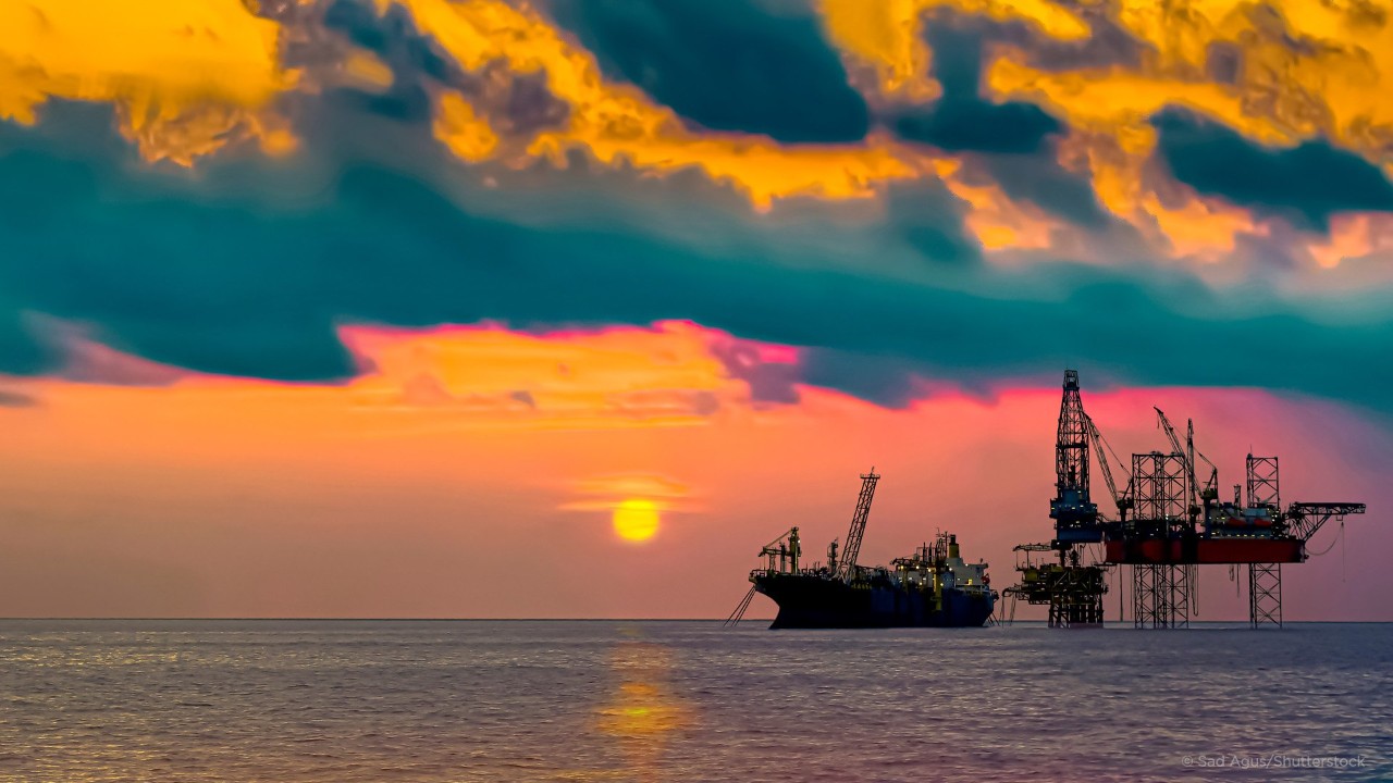 Close up of large blue merchant crago ship in the middle of the ocean underway. Performing cargo export and import operations with sun rays, horizon line and beautiful sky.; Shutterstock ID 1468222610; purchase_order: Graphics; job: ; client: Chris Reeves; other: 