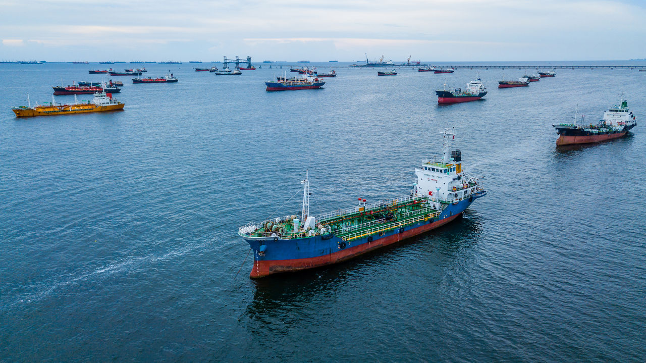 Aerial view of oil product tanker, LPG tanker and chemical tanker ship loading in port.
